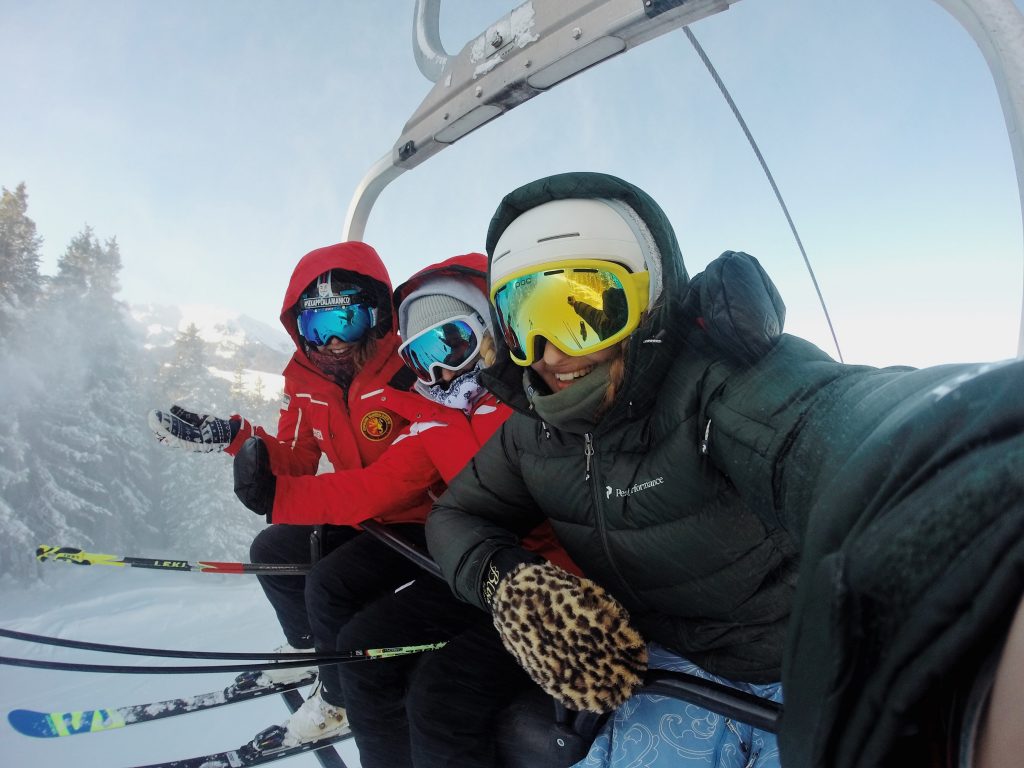 friends on ski lift smiling